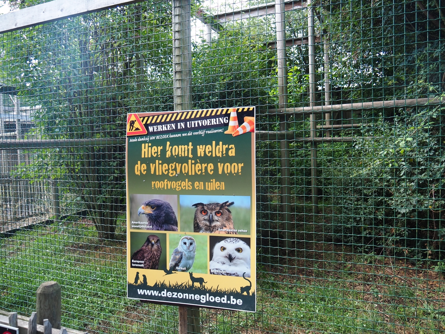 Unoccupied bird-of-prey aviary and sign