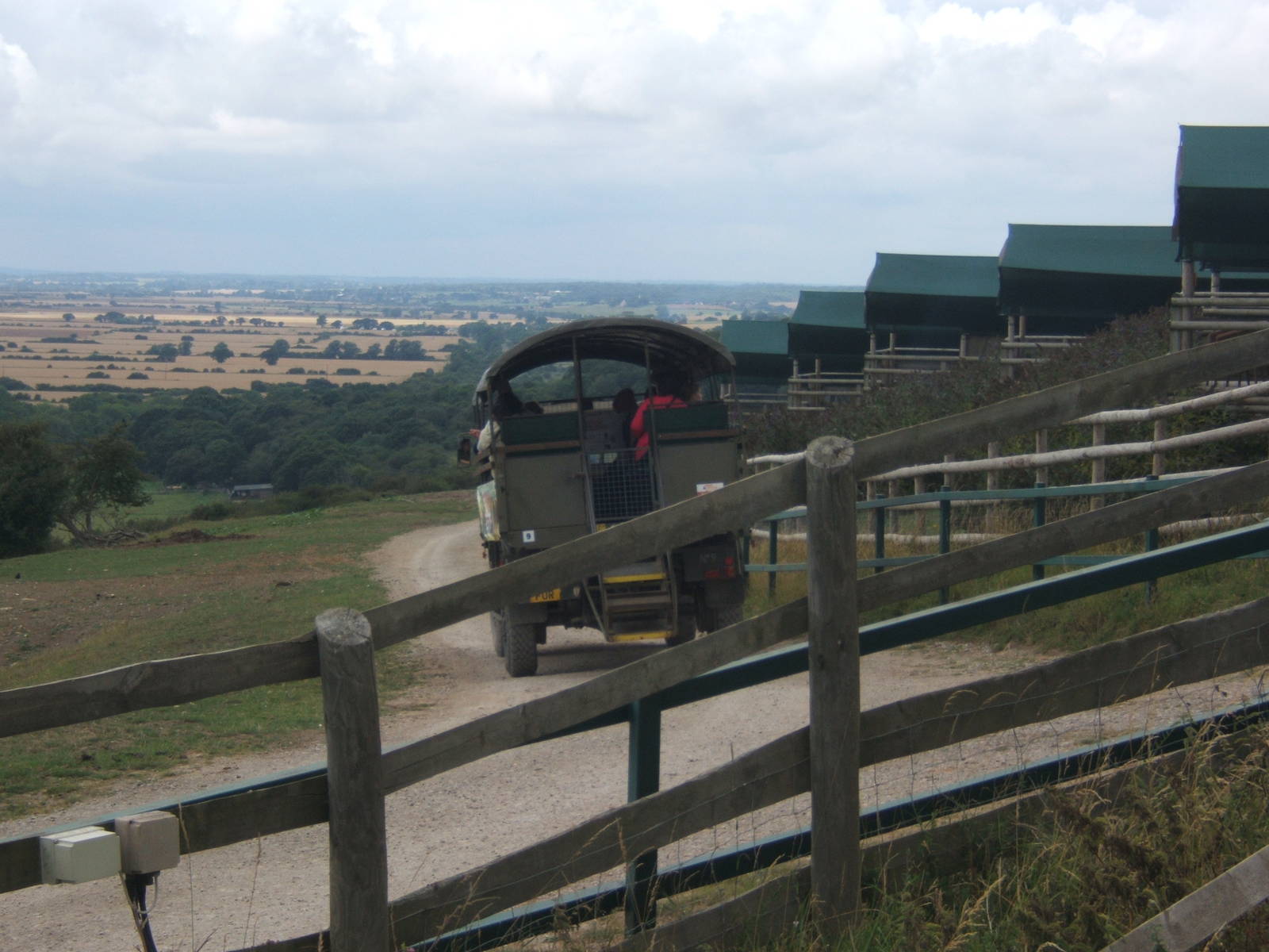 View of truck passing the lodges in the African Experience