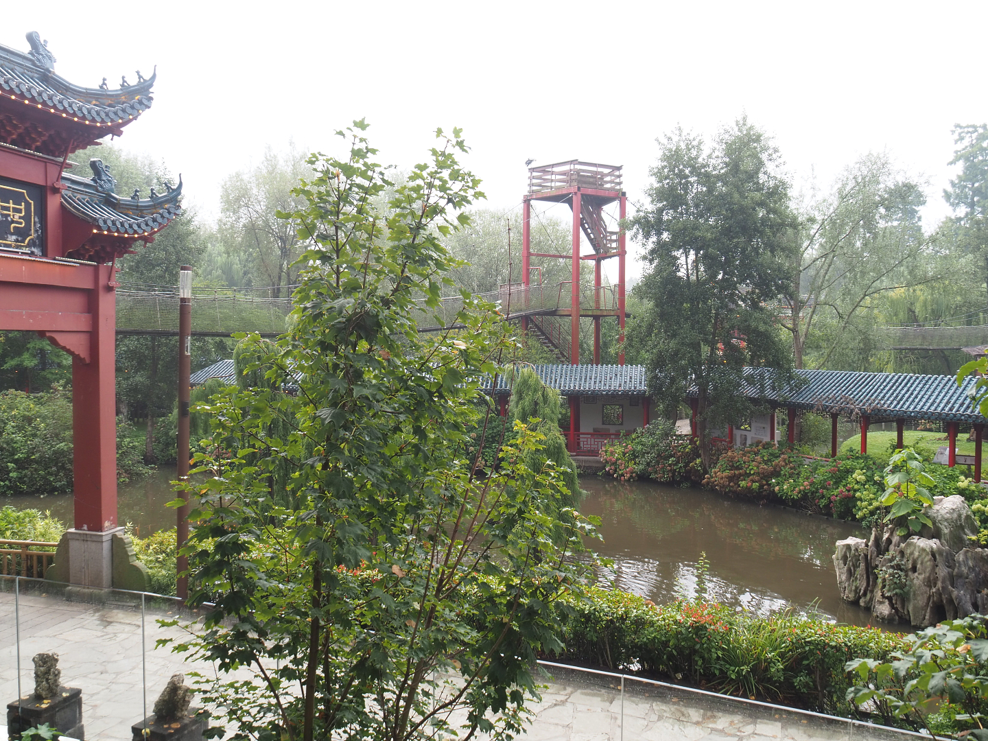 View to lower area from upper otter viewing area with viewing corridor and adventure bridge tower, 2022-09-15