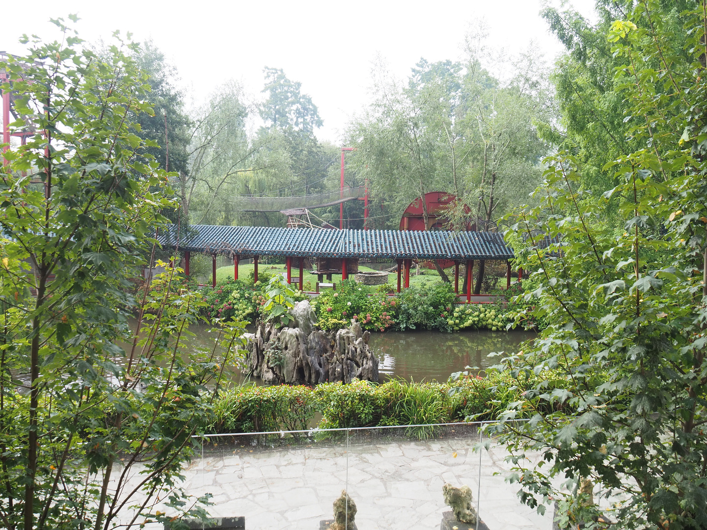 View to lower area from upper otter viewing area with viewing corridor and part of gibbon/goral/crane exhibit, 2022-09-15