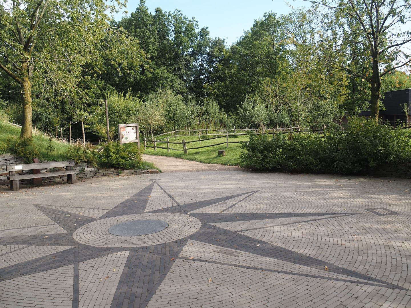 Walkway towards entrance, square with compass rose and cattle paddock in the entrance area, 2024-08-21