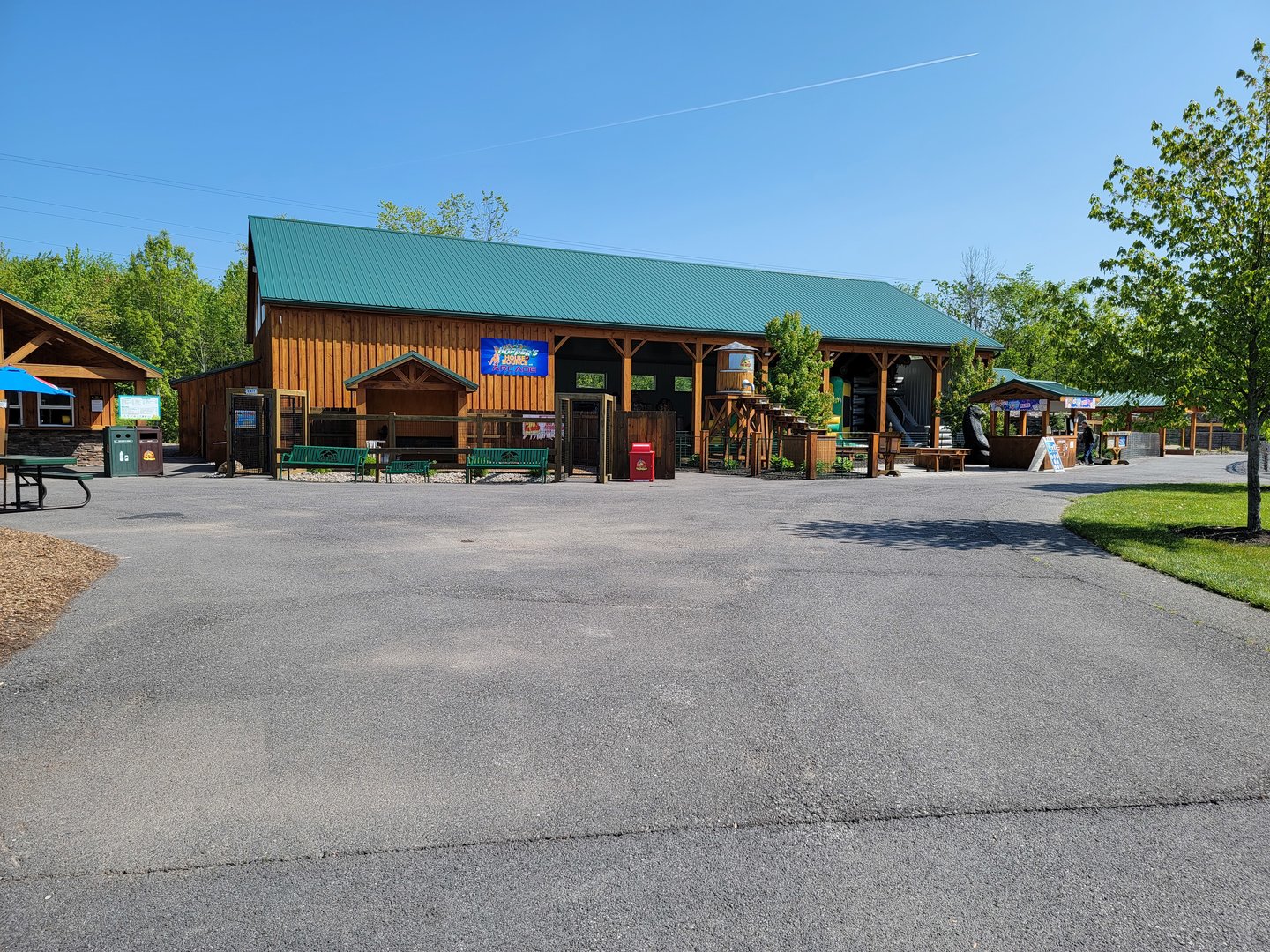 Wild Animal Park - Entertainment area with bounce house, arcade games, loud pop music