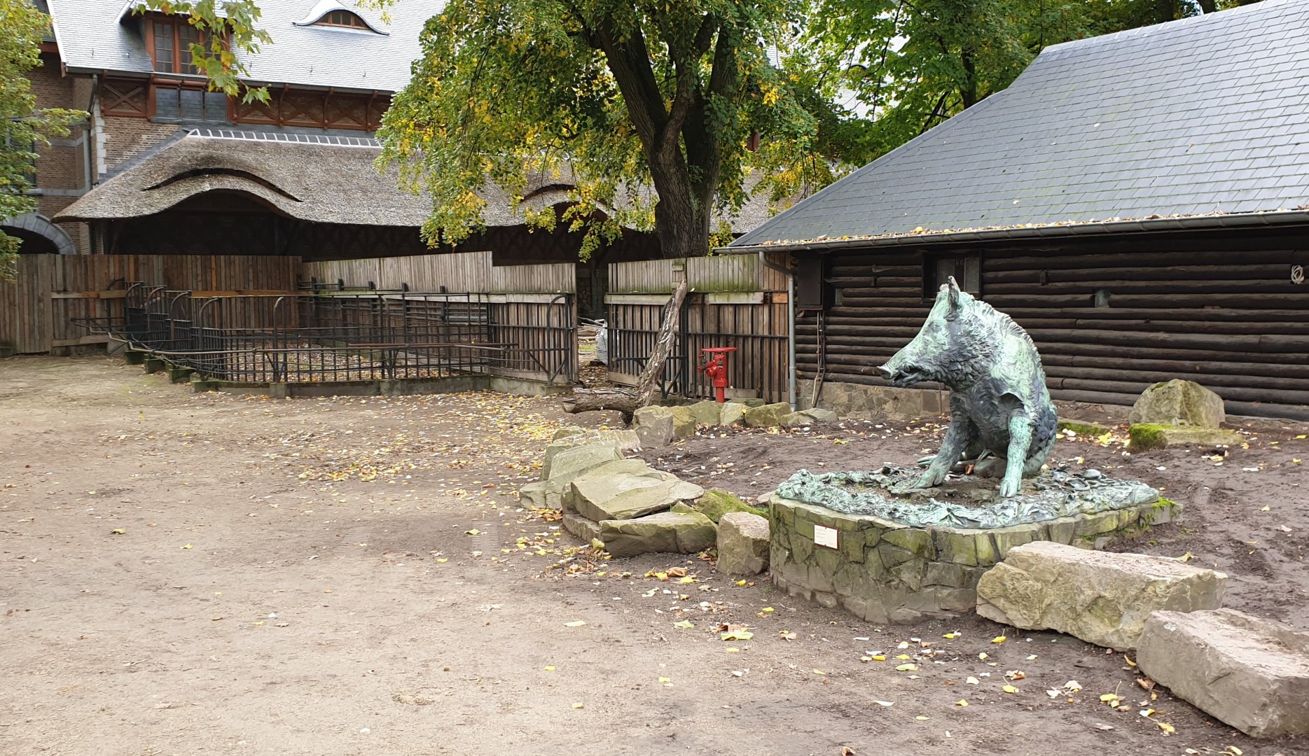 Wild boar statue and empty enclosures